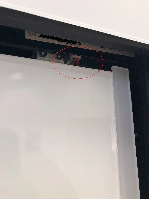Close-up of pet door internal wiring and mounting hardware, highlighting secure installation details.