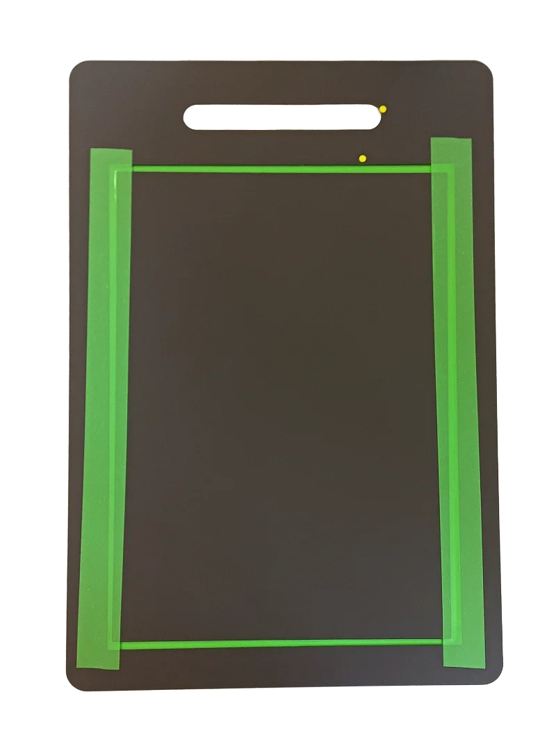 Black pet door panel with green sealing strips and handle cutout for energy-efficient pet access