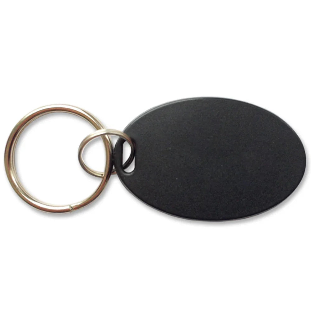Black oval pet door access key fob with metal ring for chip-enabled entry systems